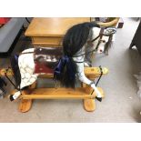 A wooden rocking horse from circa 2000s. Approx 110cm long and 100cm high. Postage D.