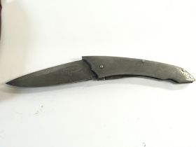 A Damascus steel folding knife with leather sheaf