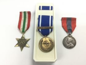 Three medals comprising an italy Star, a Yugoslavi