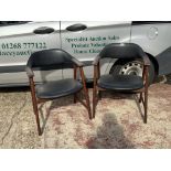 A pair Mid Century 1960s Danish teak and black vinyl dining chairs.