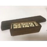 An antique bone and ebony dominoes set and a marke