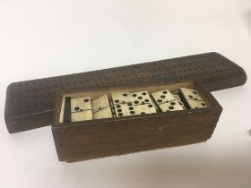 An antique bone and ebony dominoes set and a marke