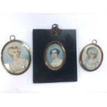 Three portrait miniatures of ladies, one in an ebo