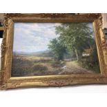 A gilt framed oil painting of a rural view painted