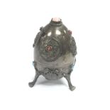 A Russian silver decorative egg set with turquoise
