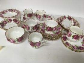A Royal Albert Old English Rose part tea and dinner service four cups saucers bowls and plates.