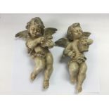 A pair of plaster cherubs ornaments, approx height