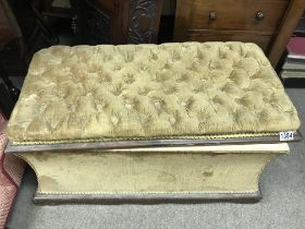 An ottoman with a hinged lid, with upholstered button back