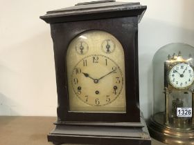 A mahogany mantle clock the silver dial with Arabi