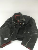 An authentic 1970s girls leather studded Punk jacket with Sex Pistols badge.