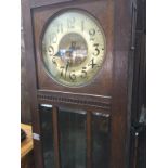 A oak long case 30 hour clock the circular dial wi