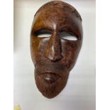 A burr wood tribal mask.