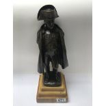 A bronze figure of Napoleon on a stepped marble base. 36cm in height