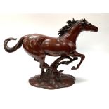 A cast bronze lacquered model of a galloping horse