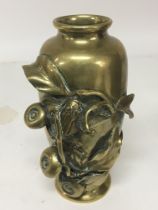 A Japanese late 19th Century brass vase with raise