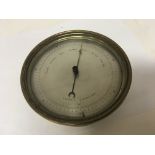 An Early 20th century brass barometer with a silve