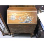 A lacquer bureau with oriental style artwork. 76w