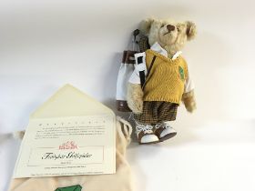 A Steiff golfer teddy bear with cloth bag. Limited