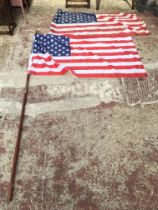 A pair of American flags, one with double a pole.