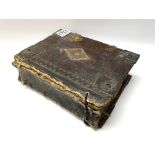 An early leather bound bible titled The Booke of C
