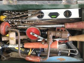 Wooden box of various carpenter tools and saws. Po