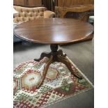 An Ercol dinning table with a circular top on a tu