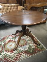 An Ercol dinning table with a circular top on a tu