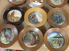 A collection of 18 framed pot lids .