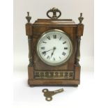 A walnut mantle clock with brass fittings, approx height 21cm. Comes supplied with a key. Shipping