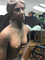 A large terracotta figure in the form of a semi nude maiden 165 cm .