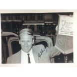 A Bobby Charlton signed photo approx 29cm x 20cm.