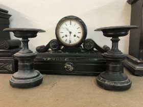 A marble clock with Roman numerals with a pair of