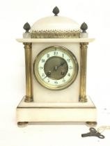 A French Onyx clock decorated with pillars, acorns