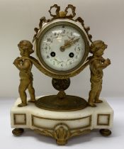 A mid 19th Century gilt bronze mantle clock. The clock having two cherubs carrying the clock face