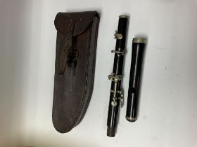 A boosey and co marching flute and case.