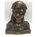 A plaster bust of a young gypsy woman raised on a