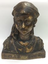 A plaster bust of a young gypsy woman raised on a