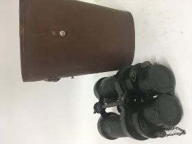 A pair of military binoculars in a leather fitted