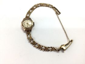A vintage ladies 9ct gold watch and strap. 13.1g