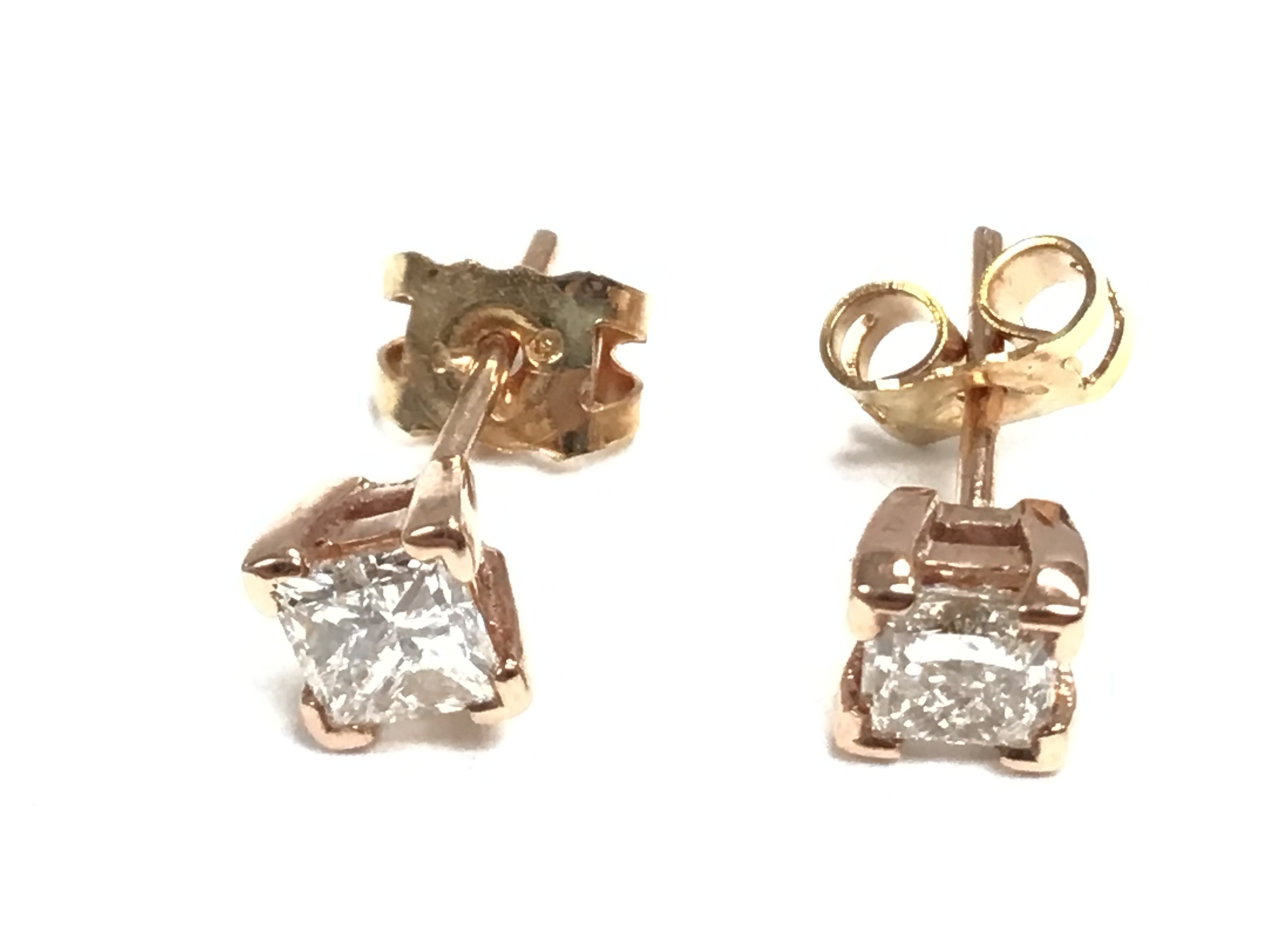 A pair of 9ct gold princess cut diamond earrings.