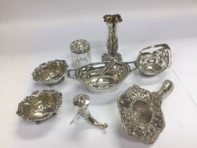 A collection of silver salts, bud vase, tea strain