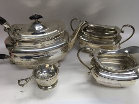 A three piece silver tea set comprising tea pot milk jug sugar bowl together with strainer 1.2 Kg .