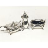 A three piece silver condiment set.