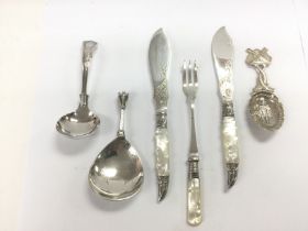 A small collection of silver cutlery. Shipping cat