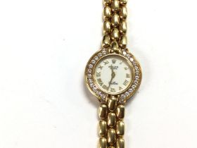 A Rolex Cellini watch in 18ct gold. 24mm case with what appears factory set diamonds around face. Wh