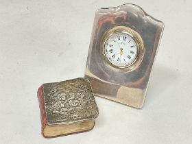 A silver clock and silver fronted bible , postage