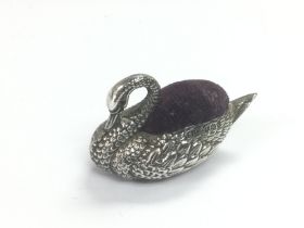 A small silver pin cushion in the form of a swan,