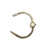 A 9ct ladies Cyma watch. Approximately 15mm case a