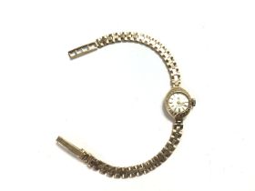 A 9ct ladies Cyma watch. Approximately 15mm case a