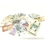 A collection of various foreign banknotes includin